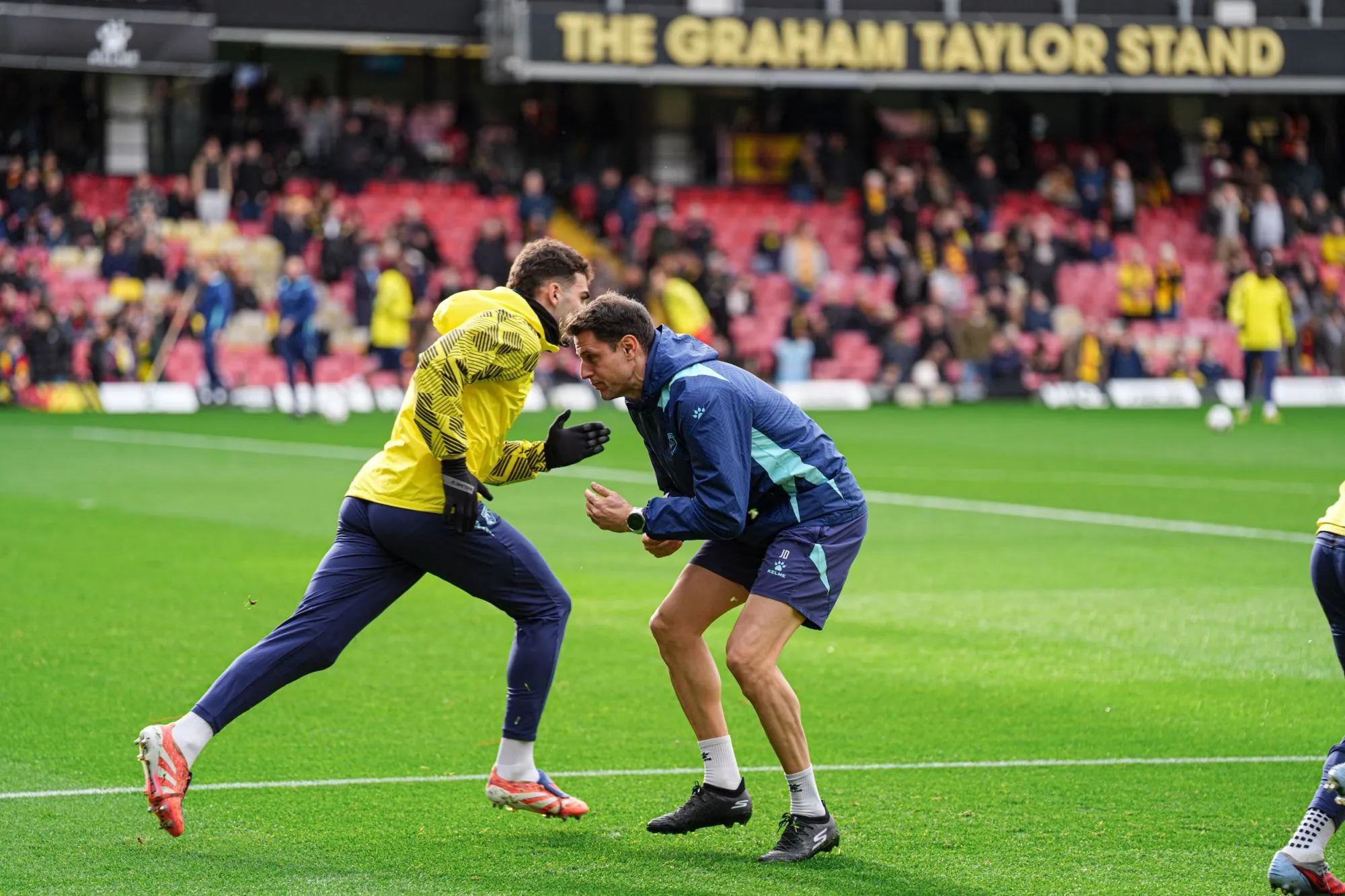 Joel Donés running a pre-match warm-up at Vicarage Road, Watford FC